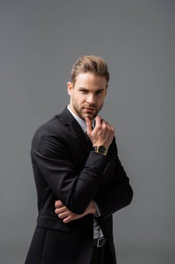 Kendine güvenen iş adamı kameraya bakarken el ele tutuşuyor.