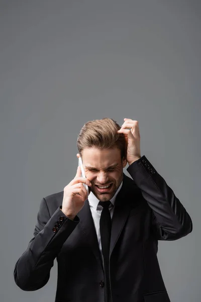 Stressed Businessman Touching Head While Talking Smartphone Isolated Grey — Stock Photo, Image