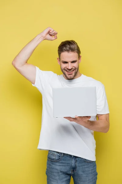 Excited Man Showing Success Gesture While Looking Laptop Yellow — Stock Photo, Image