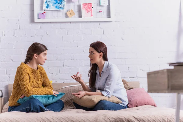 Madre Gesto Mientras Habla Con Hija Adolescente Dormitorio —  Fotos de Stock