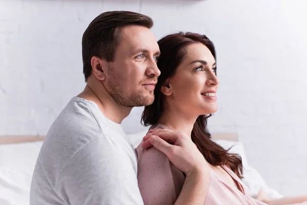 Man Embracing Smiling Brunette Wife Bedroom — Stock Photo, Image