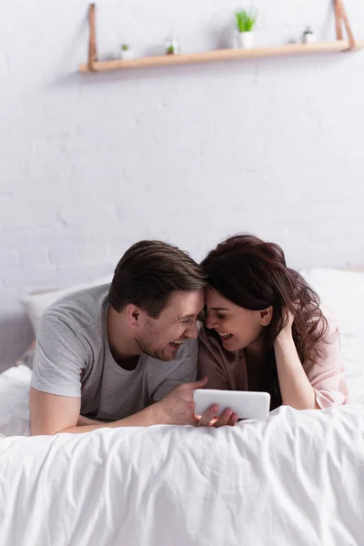 Cheerful Adult Couple Smartphone Lying Bed — Stock Photo, Image