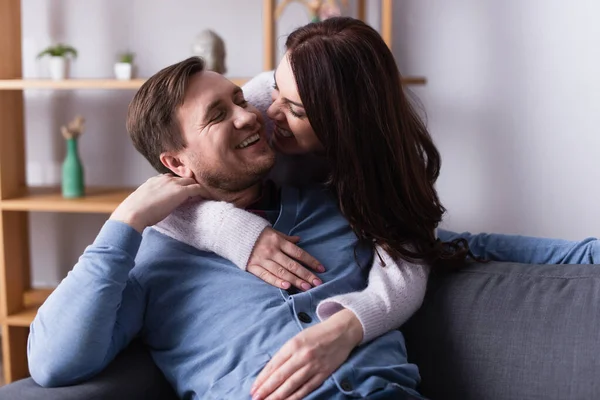 Woman Hugging Looking Husband Sofa — Stock Photo, Image