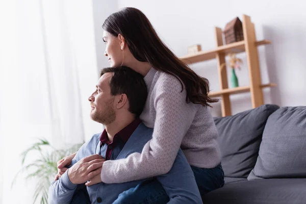 Woman Embracing Husband Looking Away Couch — Stock Photo, Image