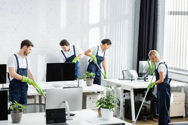 Interracial Cleaners Rubber Gloves Holding Mops Office — Stock Photo, Image