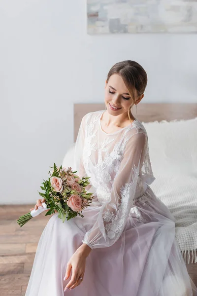 Pretty Bride Holding Wedding Bouquet While Sitting Bedroom — Stock Photo, Image
