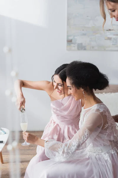 Cheerful Woman Pouring Champagne Glass African American Bride Bedroom — Stock Photo, Image