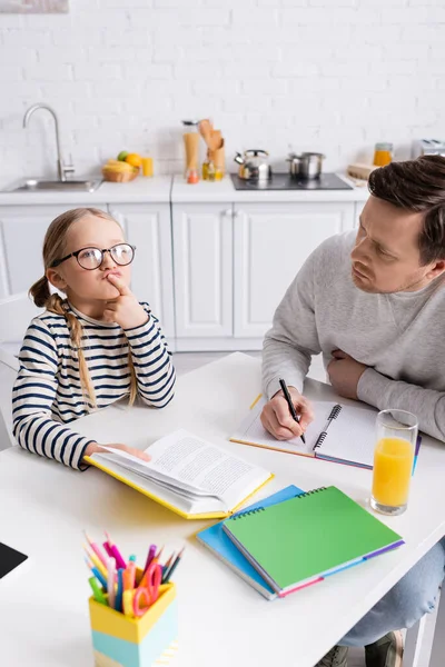 Thoughtful Girl Book Touching Lips While Doing Homework Father — Stock Photo, Image