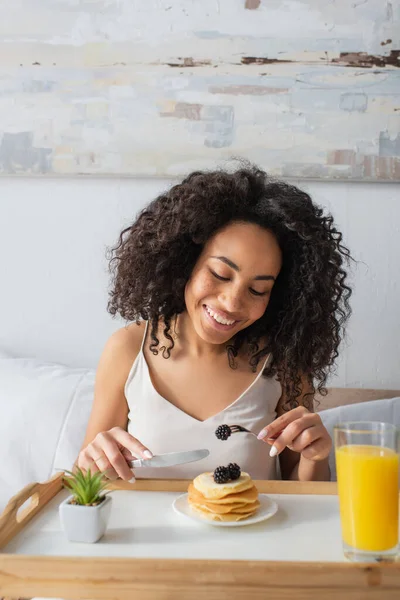 Mujer Afroamericana Feliz Sosteniendo Tenedor Con Mora Cerca Panqueques Bandeja — Foto de Stock