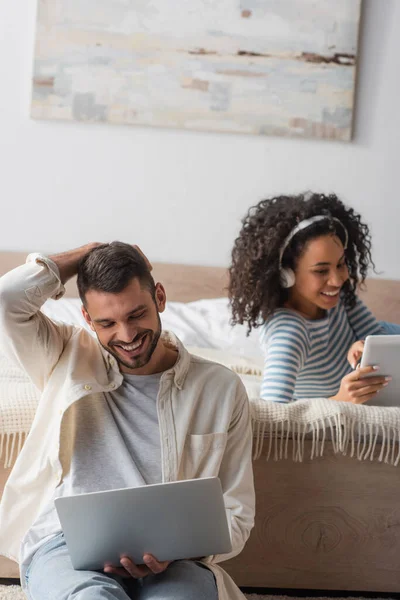 Happy Bearded Man Using Laptop African American Woman Wireless Headphones — Stock Photo, Image