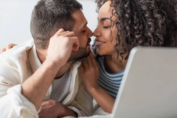 Interracial Couple Kissing While Chilling Bed Laptop — Stock Photo, Image