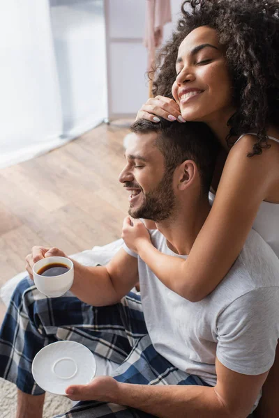 Curly African American Woman Hugging Cheerful Boyfriend Cup Coffee — Stock Photo, Image