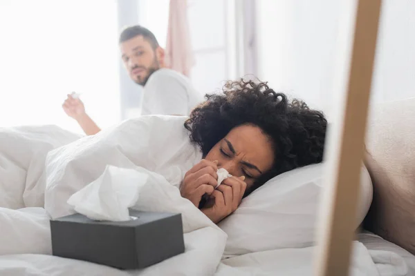 Ill African American Woman Lying Blanket Sneezing Napkin Worried Boyfriend — Stock Photo, Image