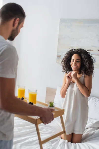 Blurred Bearded Man Holding Tray Breakfast Happy African American Girlfriend — Stock Photo, Image