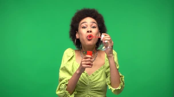 Sad African American Woman Blowing Soap Bubbles Isolated Green — Stock Video