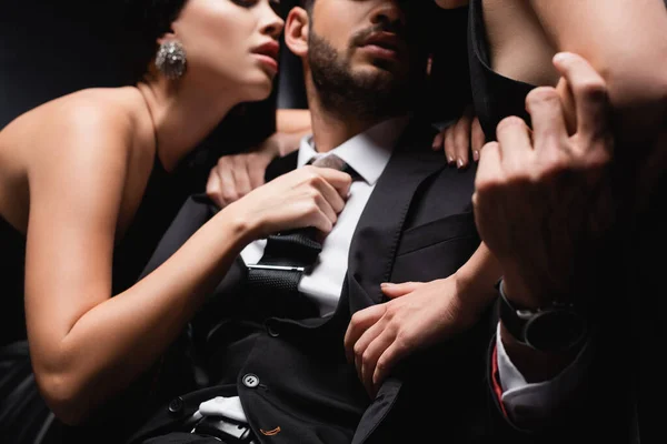 Cropped View Hot Women Undressing Businessman Blurred Black Background — Stock Photo, Image