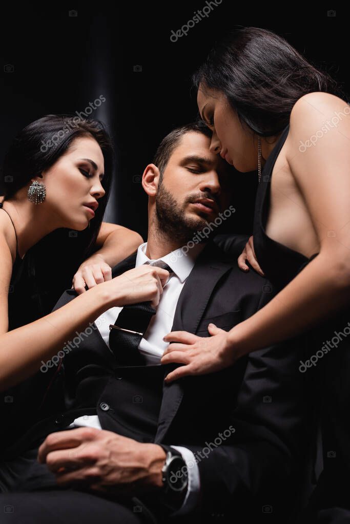 Black women undressing Sensual Women Undressing Businessman In Suit On Black