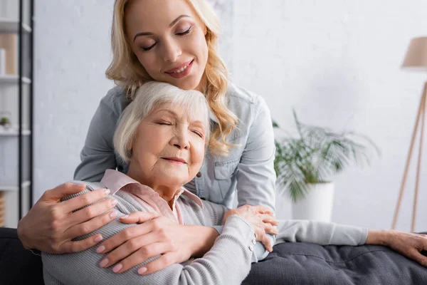 Adult Woman Smiling Hugging Grey Haired Mother — Stock Photo, Image