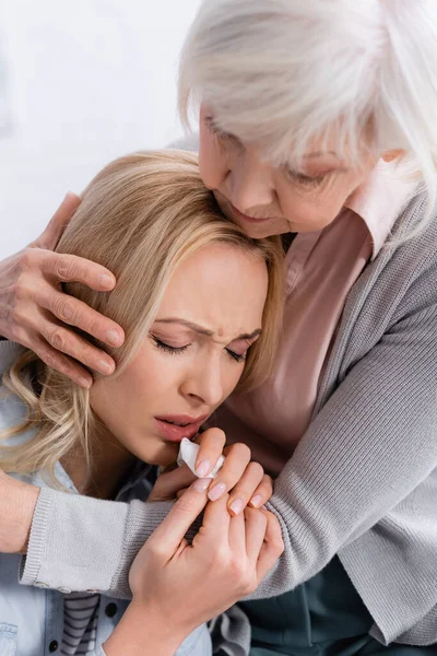 Crying Woman Holding Napkin Grey Haired Mother Embracing Home — Stock Photo, Image