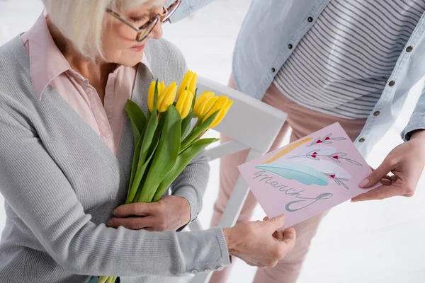 Woman Holding Greeting Card March Lettering Senior Mother Tulips — Stock Photo, Image