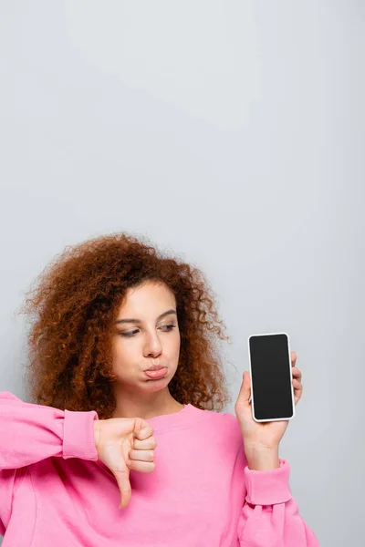 Hoşnutsuz Bir Kadın Dudaklarını Büzüyor Parmağıyla Akıllı Telefonun Yanında Gri — Stok fotoğraf