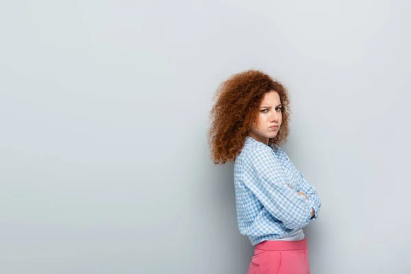 Offended Woman Puffing Cheeks While Standing Crossed Arms Grey Background — Stock Photo, Image