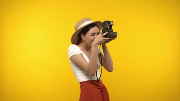 Γυναίκα Καπέλο Sun Χρησιμοποιώντας Vintage Κάμερα Απομονωμένη Κίτρινο — Αρχείο Βίντεο