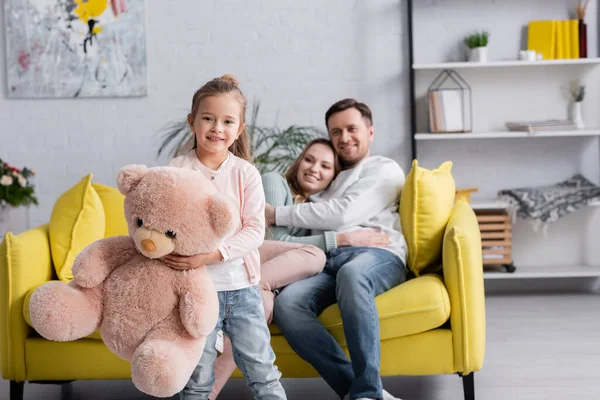 Happy Girl Soft Toy Looking Camera Parents — Stock Photo, Image