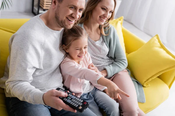 Smiling Man Holding Remote Controller Kid Pointing Finger Wife — Stock Photo, Image