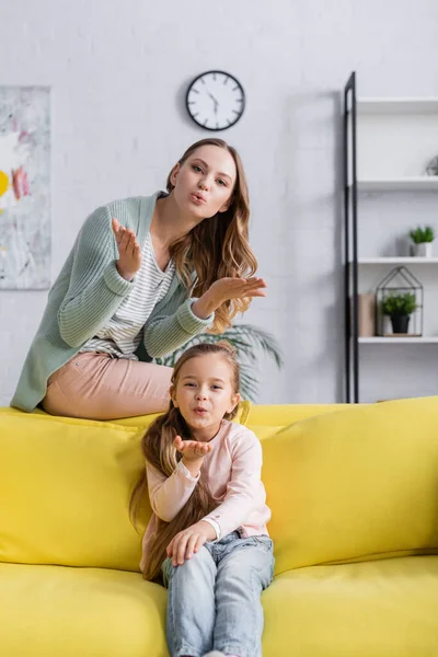 Mother Kid Blowing Air Kiss Camera Couch — Stock Photo, Image