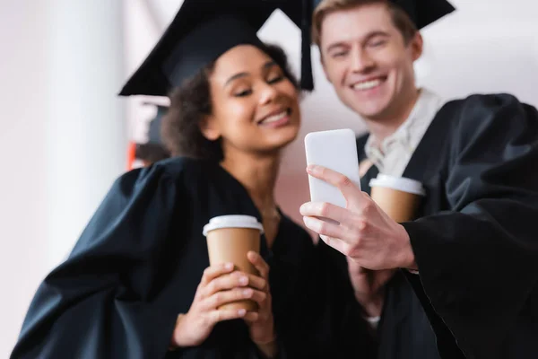 Smartphone Hand Graduate Blurred Background African American Friend Paper Cup — Stock Photo, Image