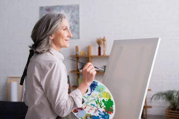 Pleased Middle Aged Woman Holding Paintbrush Palette Colorful Paints Blank — Stock Photo, Image