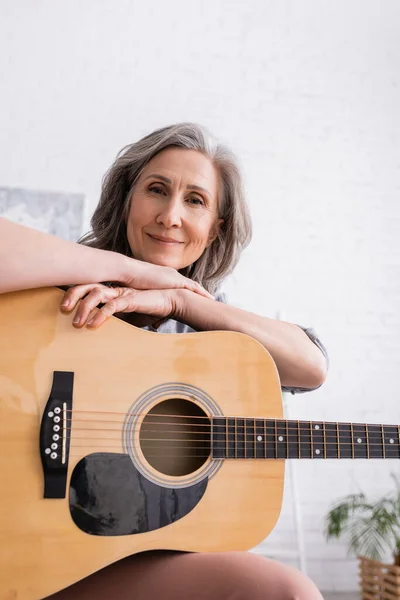 Pleased Mature Woman Grey Hair Holding Acoustic Guitar Living Room — Stock Photo, Image