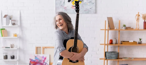 Joyful Mature Woman Grey Hair Standing Acoustic Guitar Living Room — Stock Photo, Image