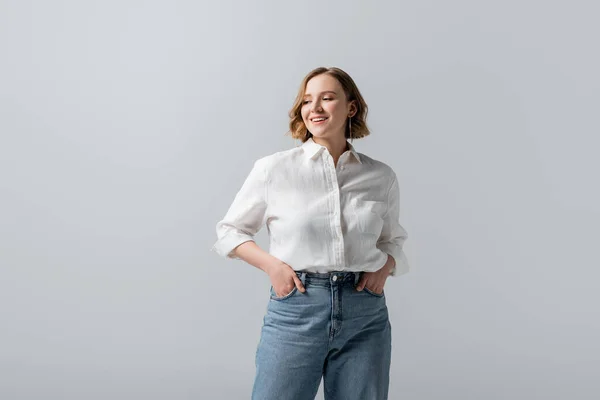 Smiling Overweight Young Woman Jeans Posing Hands Pockets Isolated Grey — Stock Photo, Image