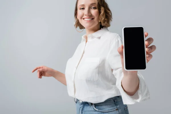 Blurred Young Overweight Woman Holding Smartphone Blank Screen Smiling Isolated — Stock Photo, Image
