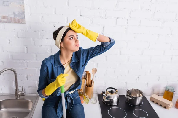 Dona Casa Exausta Luvas Borracha Segurando Esfregona Bancada Cozinha — Fotografia de Stock