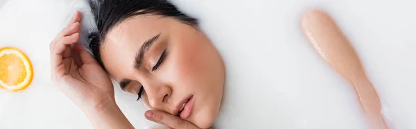 Woman Closed Eyes Holding Hands Face While Bathing Milk Banner — Stock Photo, Image