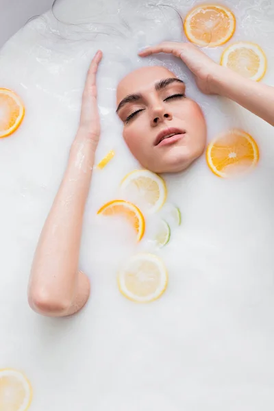 Pretty Woman Closed Eyes Bathing Milk Sliced Citruses — Stock Photo, Image