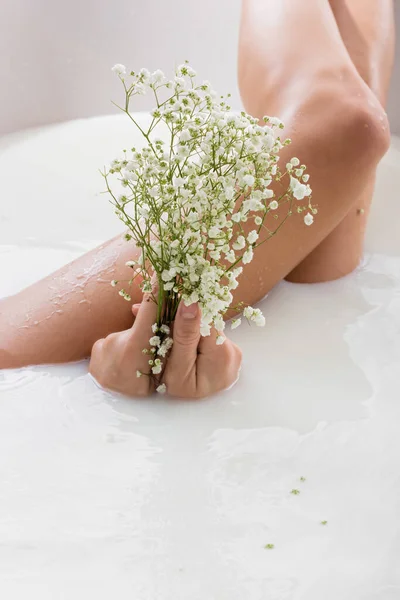 Partial View Woman Holding White Tiny Flowers While Enjoying Milk — Stock Photo, Image