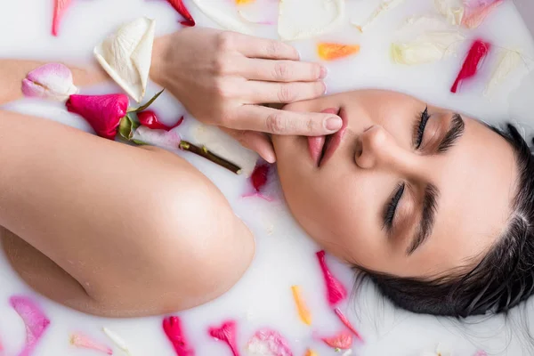 Sensual Woman Touching Lips While Enjoying Floral Bath Milk — Stock Photo, Image