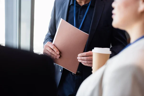 Cropped View Businessman Holding Paper Folder Colleague Coffee Blurred Foreground — Stock Photo, Image