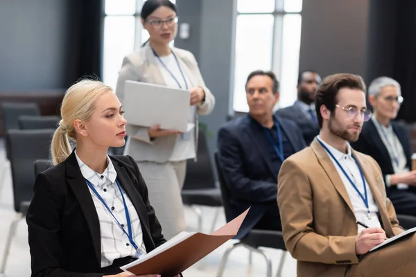 Affärskvinna Håller Papper Mapp Nära Suddiga Kollegor Konferensrummet — Stockfoto