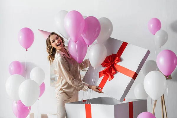 Positive Woman Standing Big Gift Box Balloons Birthday Celebration Home — Stock Photo, Image