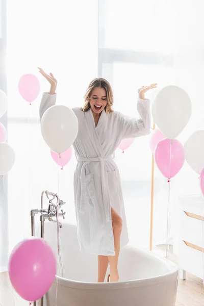 Cheerful Woman Bathrobe Standing Bathtub Balloons — Stock Photo, Image