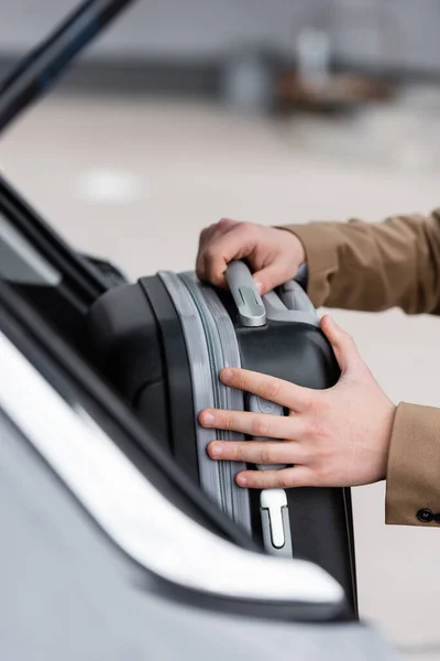 Cropped View Man Putting Suitcase Car Trunk — Stok fotoğraf