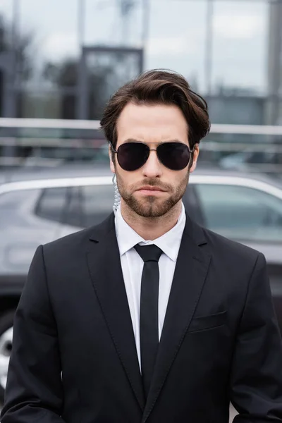 Bearded Bodyguard Suit Sunglasses Security Earpiece Modern Car Blurred Background — Stok fotoğraf