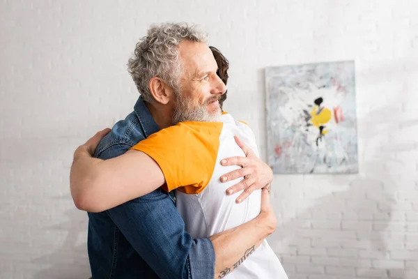 Mature Father Embracing Son Home — Stock Photo, Image