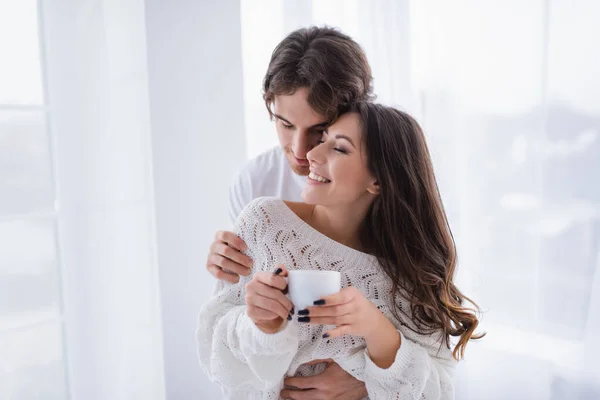 Young Man Embracing Smiling Girlfriend Cup Coffee — Stock Photo, Image