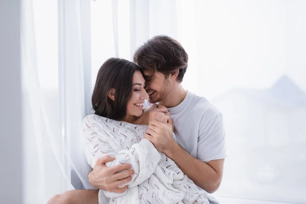 Smiling Man Embracing Girlfriend Curtain Home — Stock Photo, Image